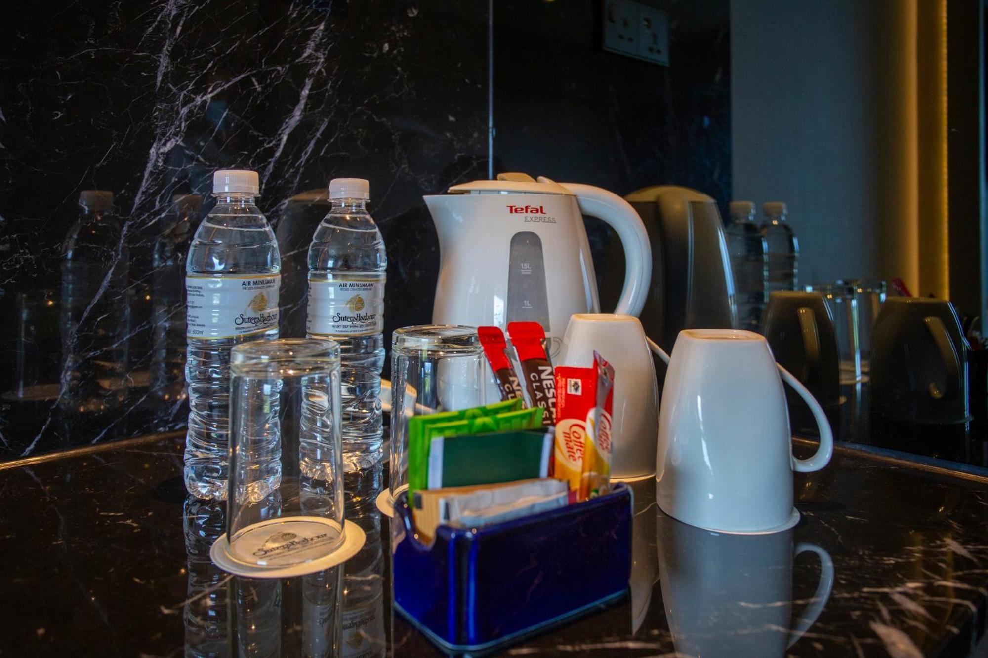 The Pacific Sutera Hotell Kota Kinabalu Exteriör bild Bottled water in a hotel room